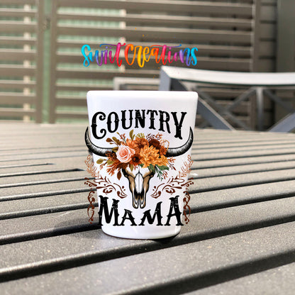 Country Mama UV DTF transfer on a white shot glass on an outdoor patio table