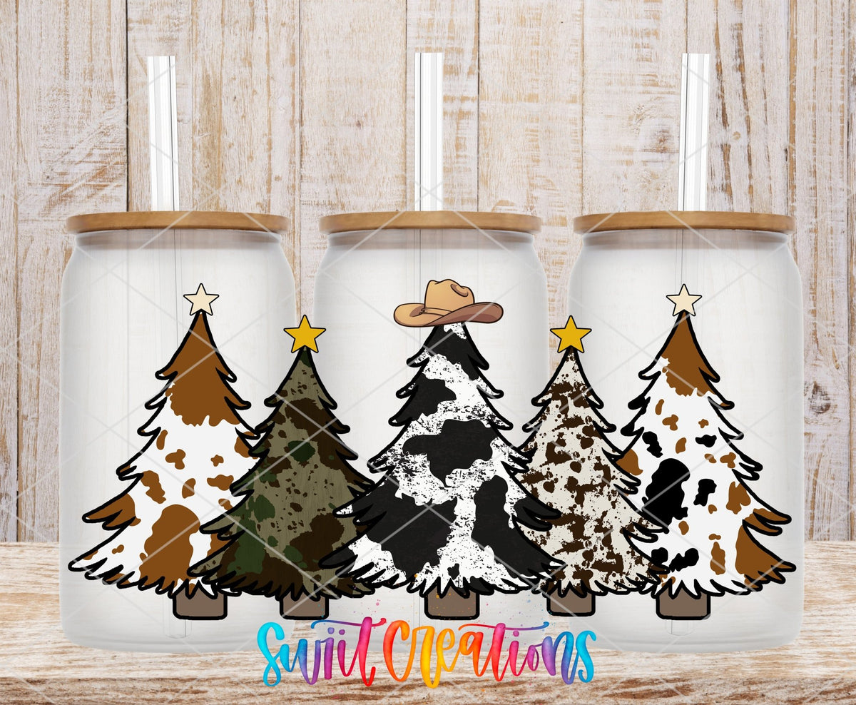 Cow Print Christmas Trees UV DTF full wrap on three clear glass cans with bamboo lids