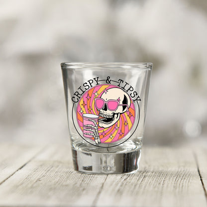 Close-up of the Crispy and Tipsy UV DTF transfer on a clear shot glass