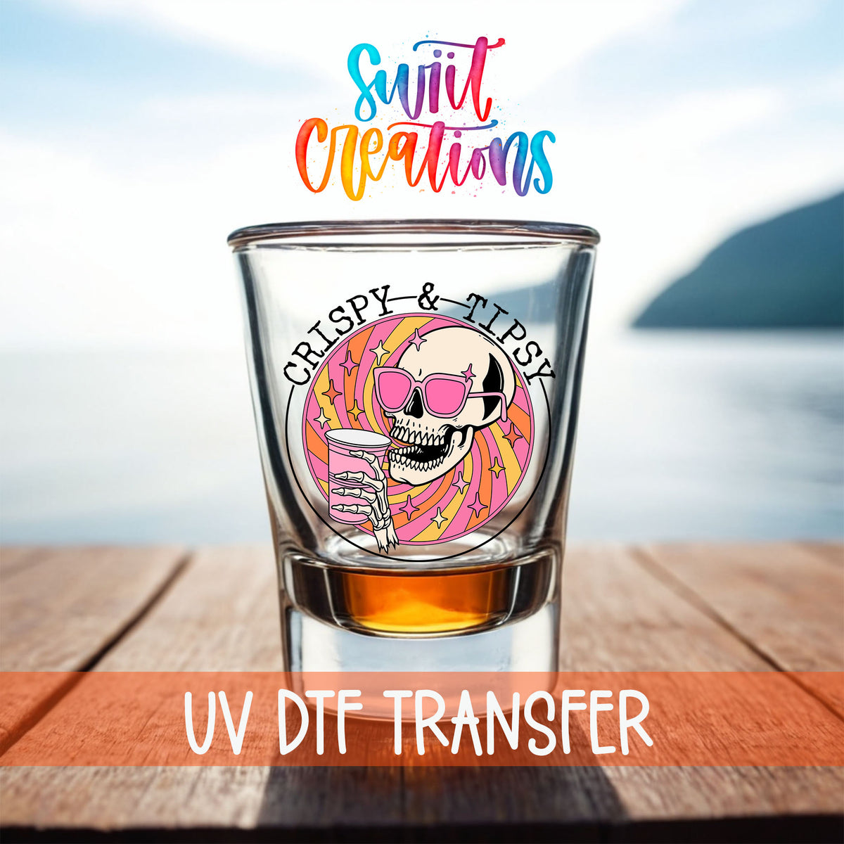 Crispy and Tipsy shot glass UV DTF transfer on a filled shot glass on a dock by the water