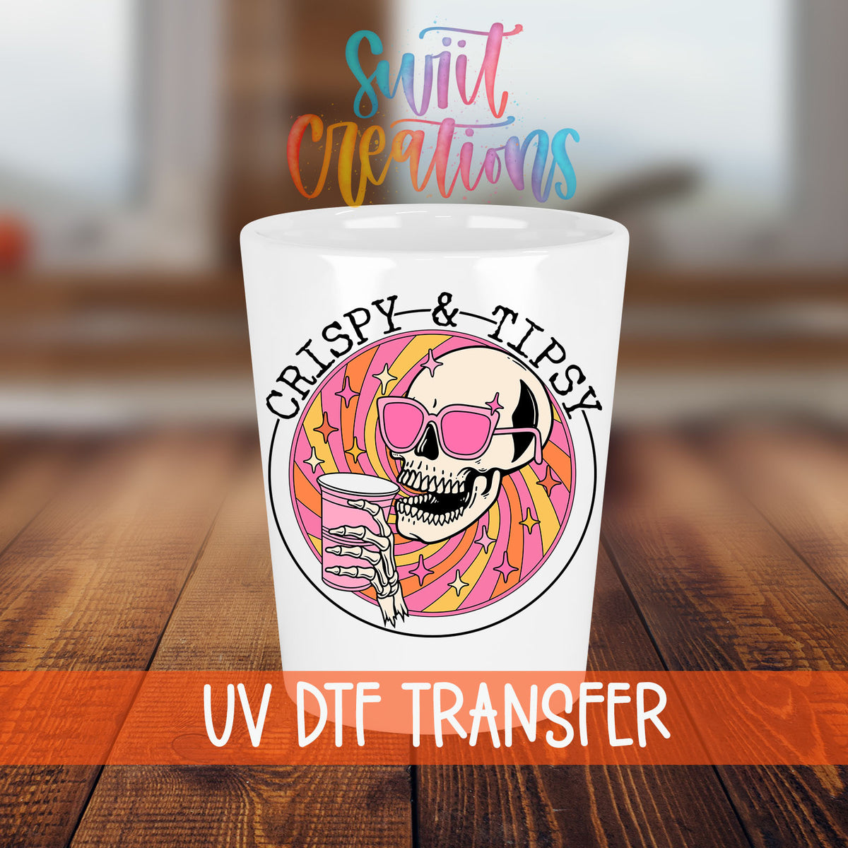 Crispy and Tipsy shot glass transfer on a white shot glass on a wooden table