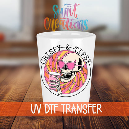 Crispy and Tipsy shot glass transfer on a white shot glass on a wooden table