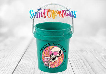 Crispy and Tipsy UV DTF transfer on a teal mini bucket on a white wood table