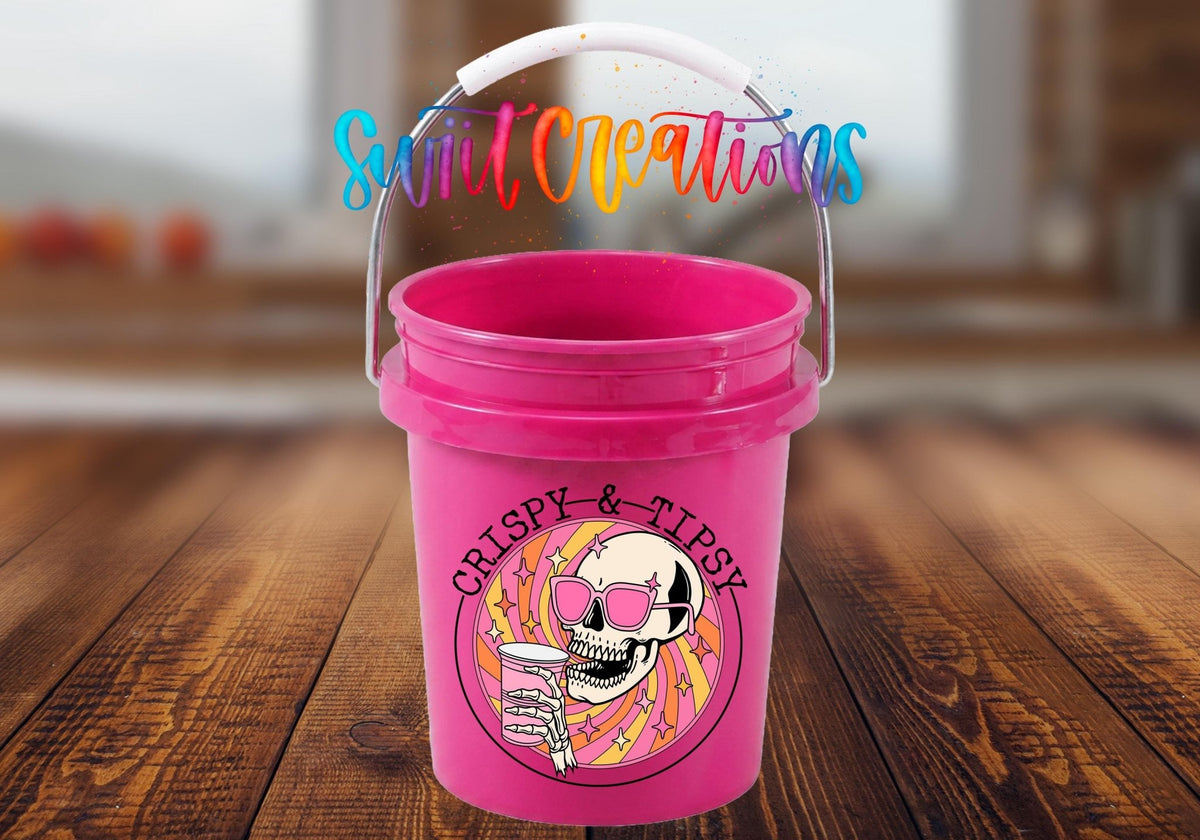 Crispy and Tipsy UV DTF transfer on a pink mini bucket on a wood table