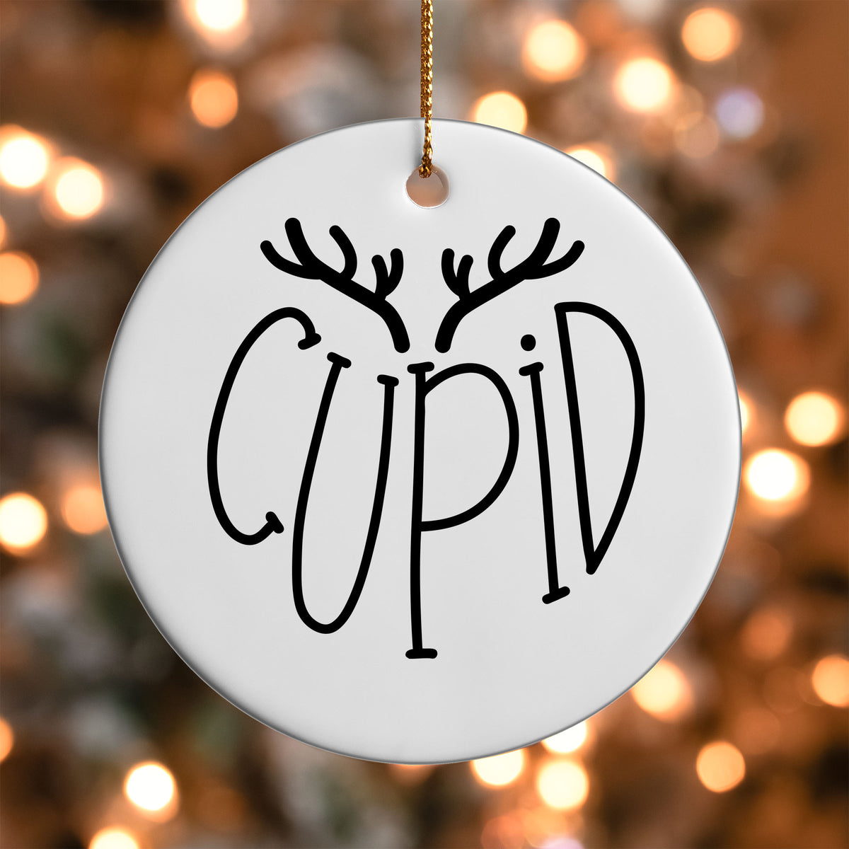 Cupid Reindeer Name ornament UV DTF transfer on a round white ornament with a bokeh light background