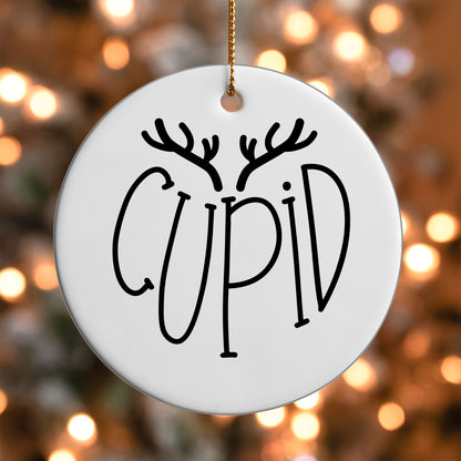 Cupid Reindeer Name ornament UV DTF transfer on a round white ornament with a bokeh light background