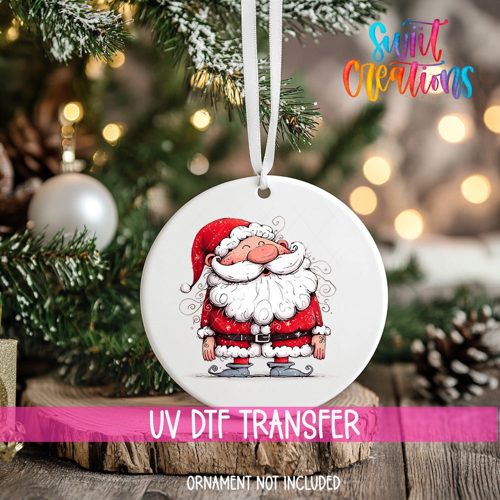 Curly Beard Santa ornament UV DTF transfer on an ornament resting on a wood slice beside a Christmas tree