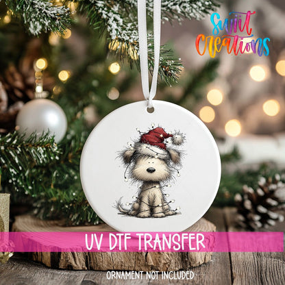 Christmas Dog with Lights ornament UV DTF transfer on an ornament resting on a wood slice beside a Christmas tree