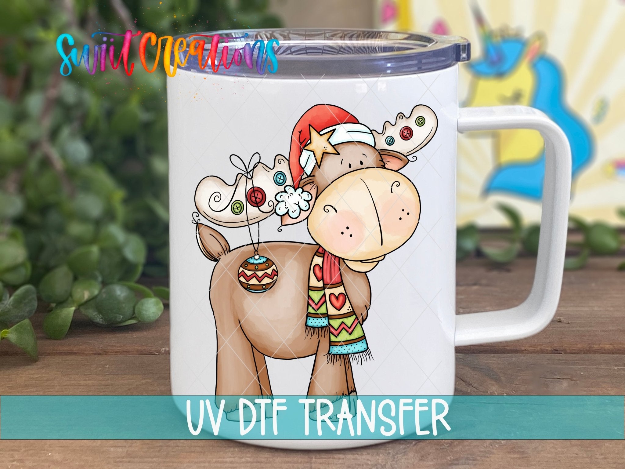 Swiit Creations Cute Christmas Moose UV DTF transfer displayed on a white coffee mug