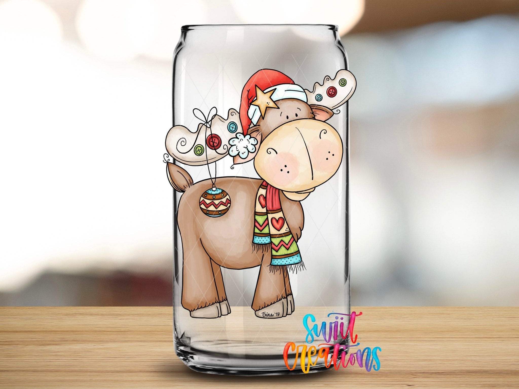 Swiit Creations Christmas moose UV DTF transfer with Santa hat and scarf on a glass can