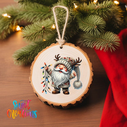 Santa Gnome with Lights UV DTF transfer on a wood slice ornament with pine branches and a red stocking