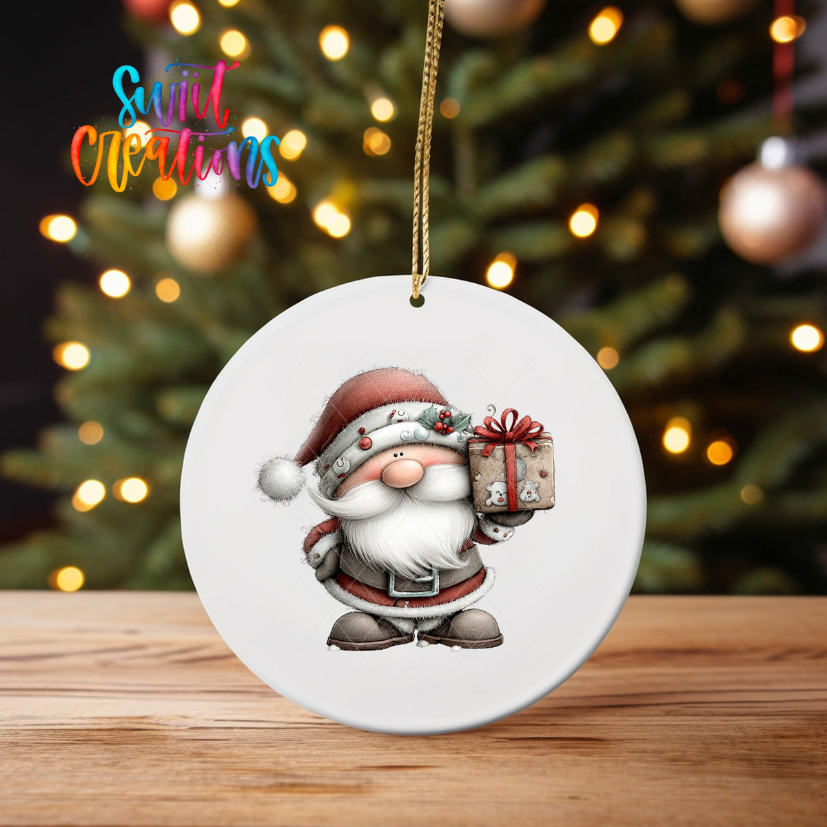 Santa with Gift ornament UV DTF transfer on an ornament on a wooden table with tree lights behind it