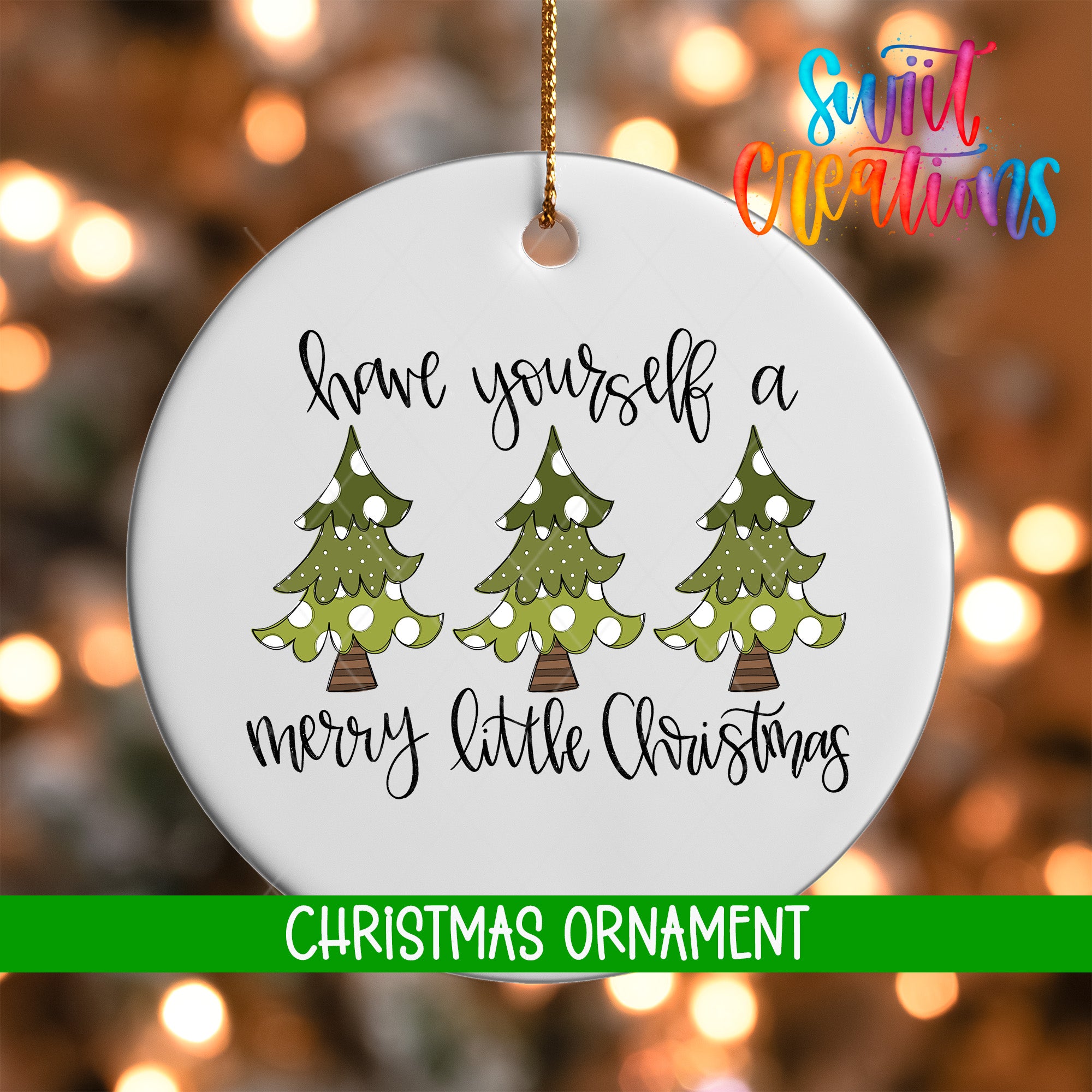 A white Christmas ornament with a message that reads "Have yourself a merry little Christmas" and three green Christmas trees with white ornaments.