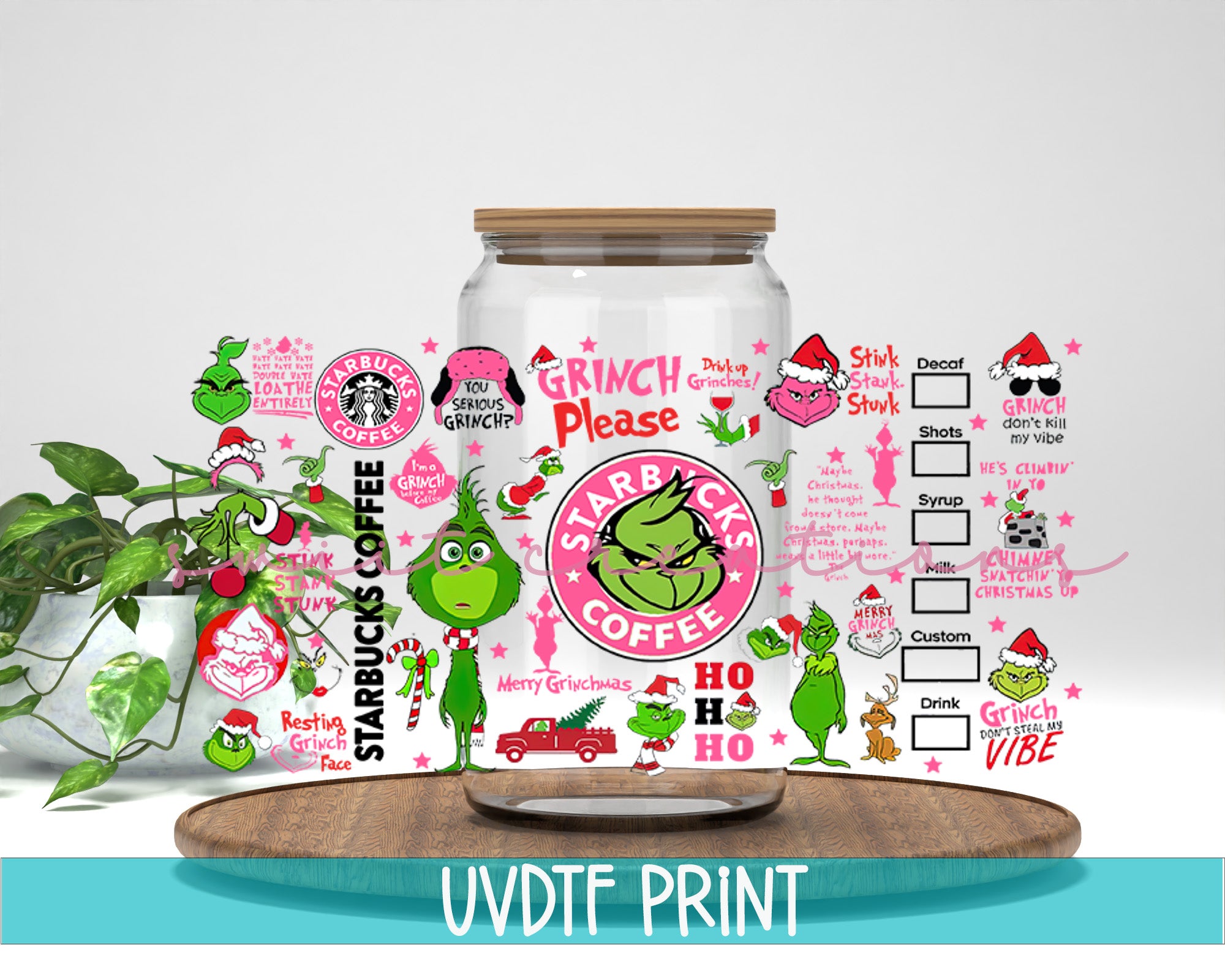 a glass jar filled with stickers next to a potted plant