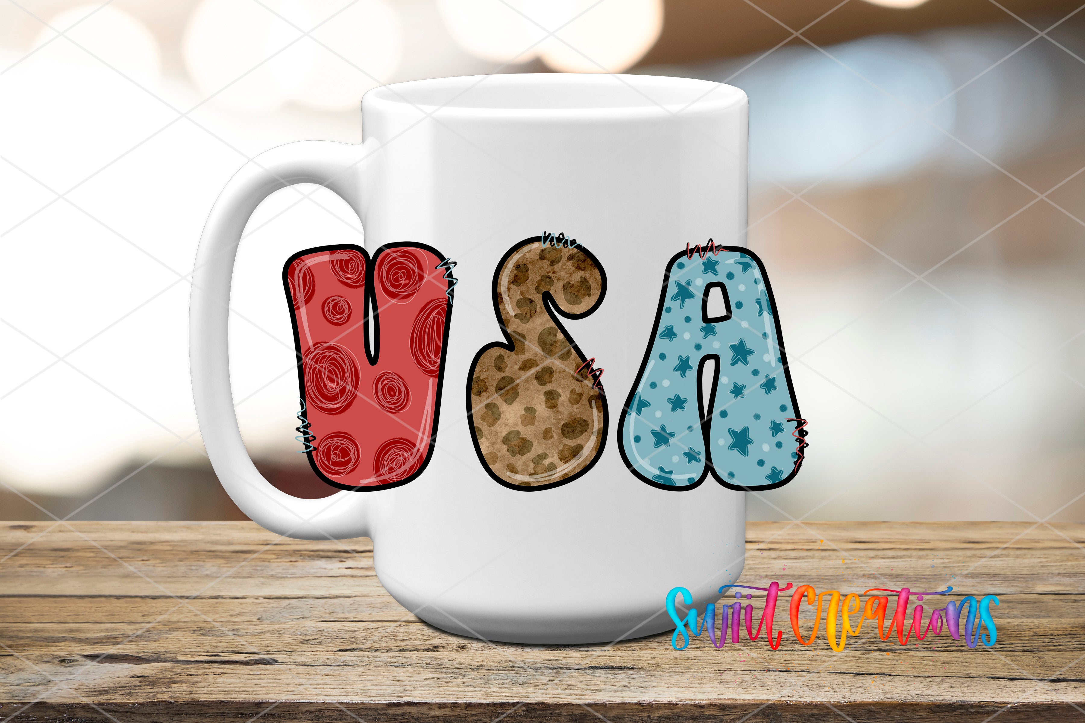 A white mug with the word "USA" spelled out in colorful letters, including a red and brown pattern, a blue and white pattern, and a leopard print pattern.