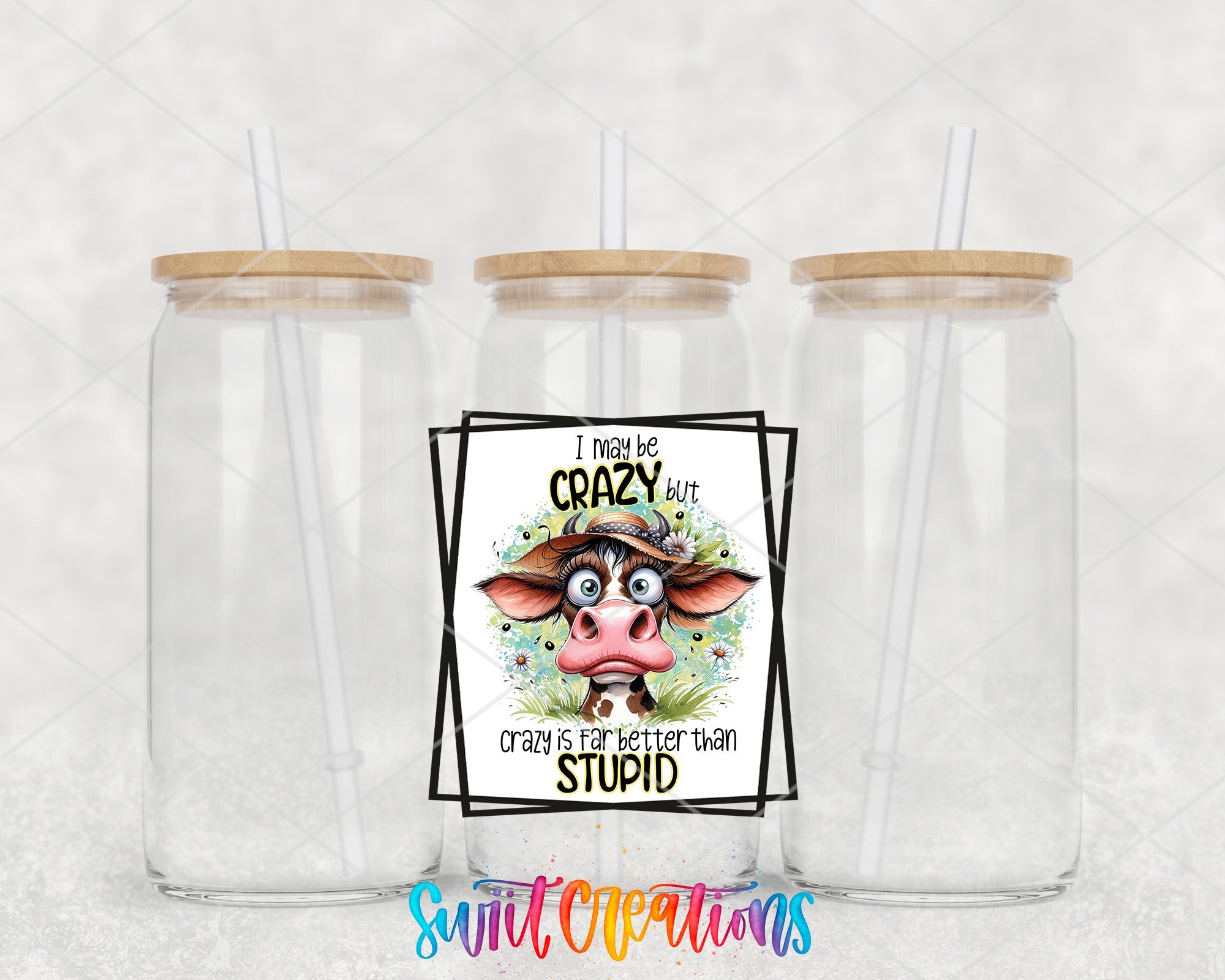 two plastic cups with straw lids and a sticker with a picture of a cow