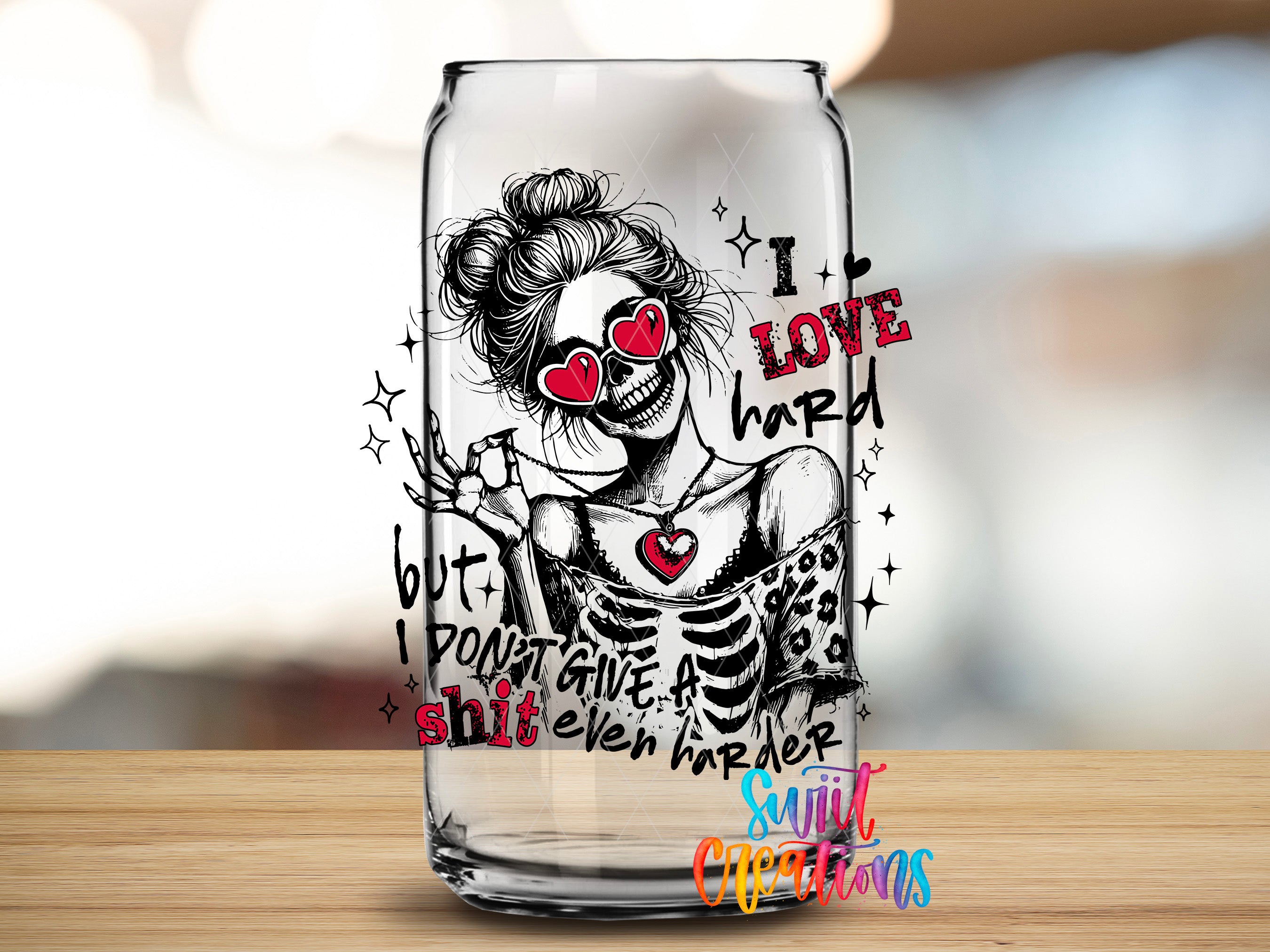 A glass can with a skull design and text printed on it.