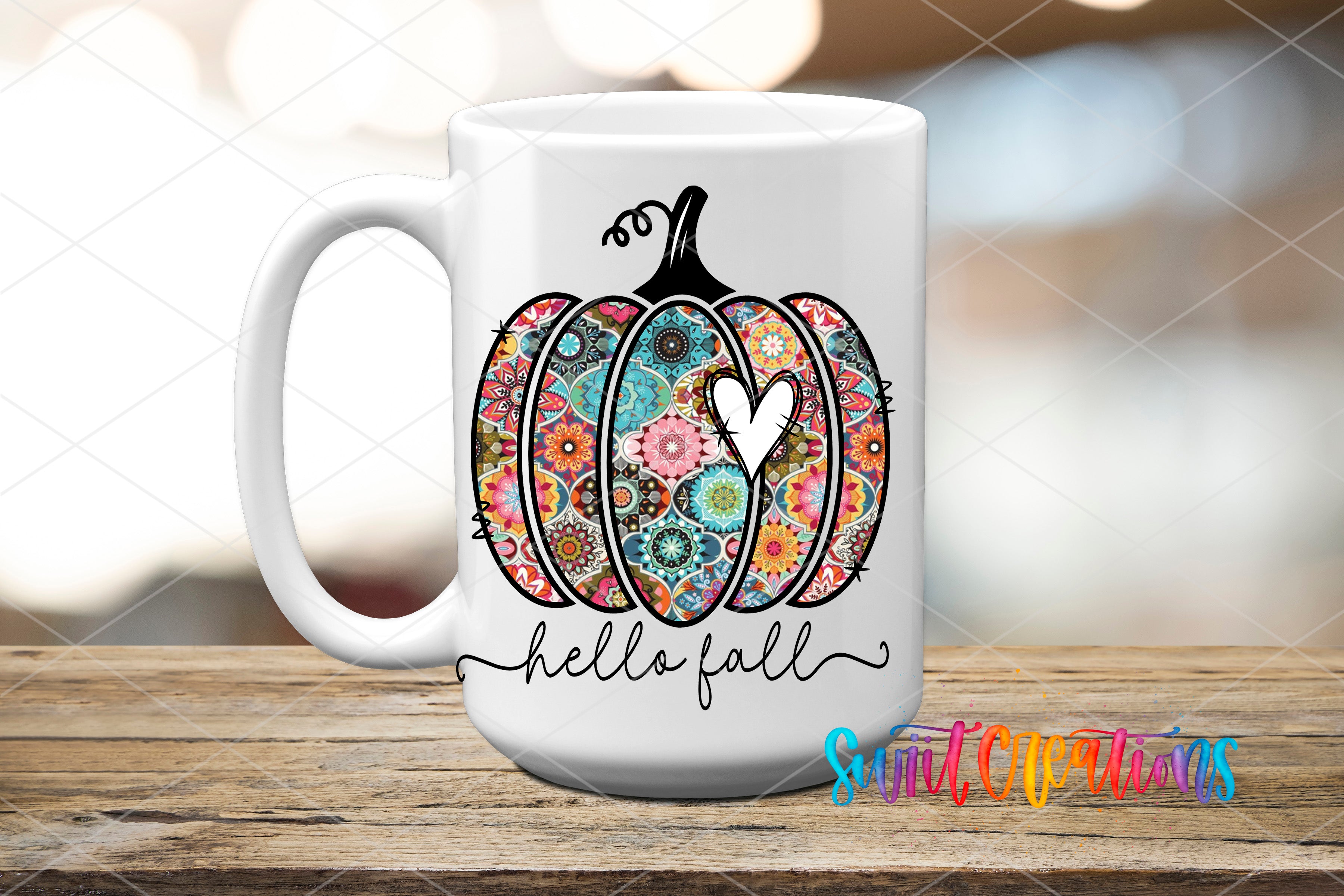 a white coffee mug with a colorful pumpkin on it