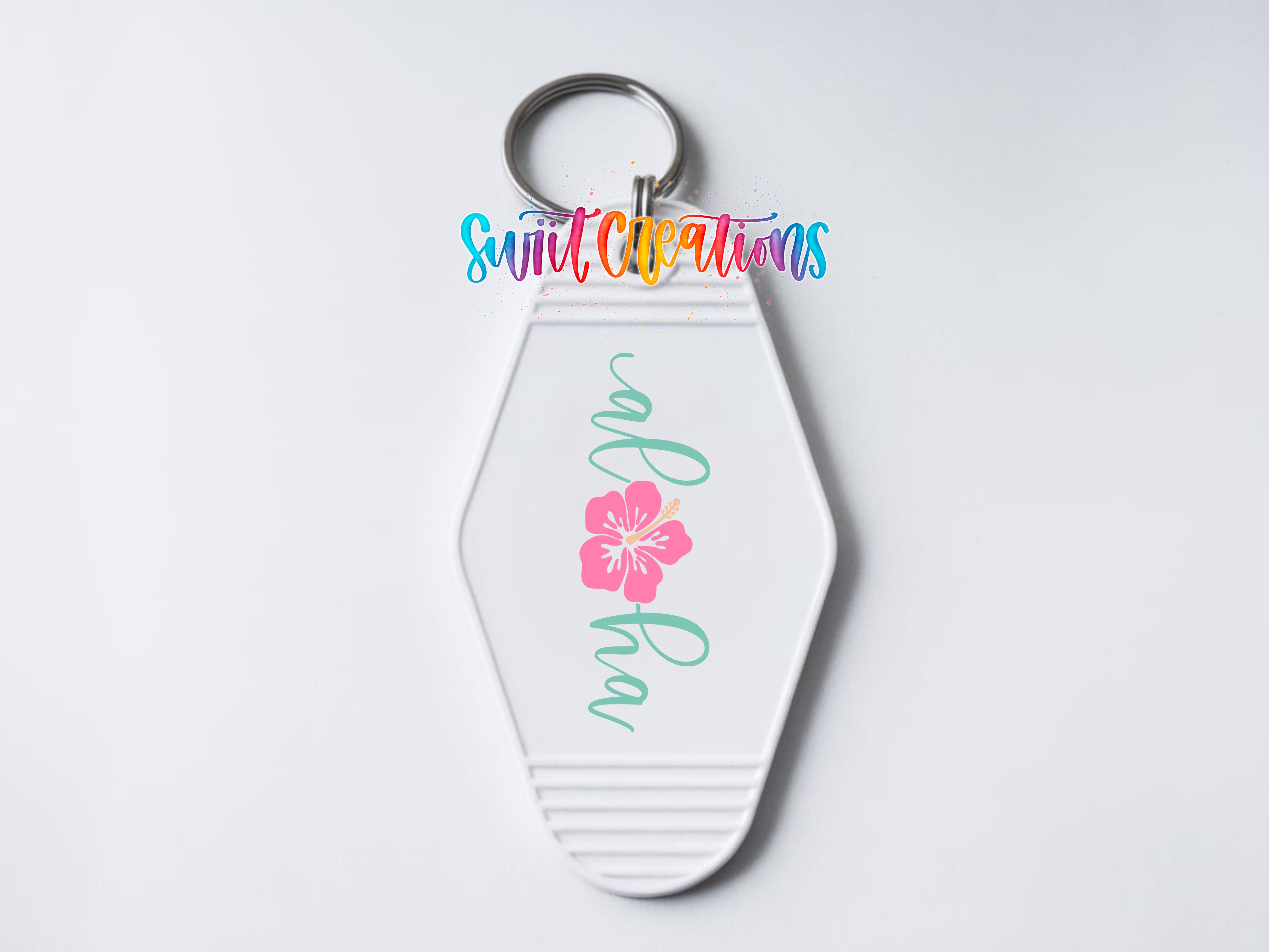 A white keychain with a floral design and the text "Aloha" printed on it.