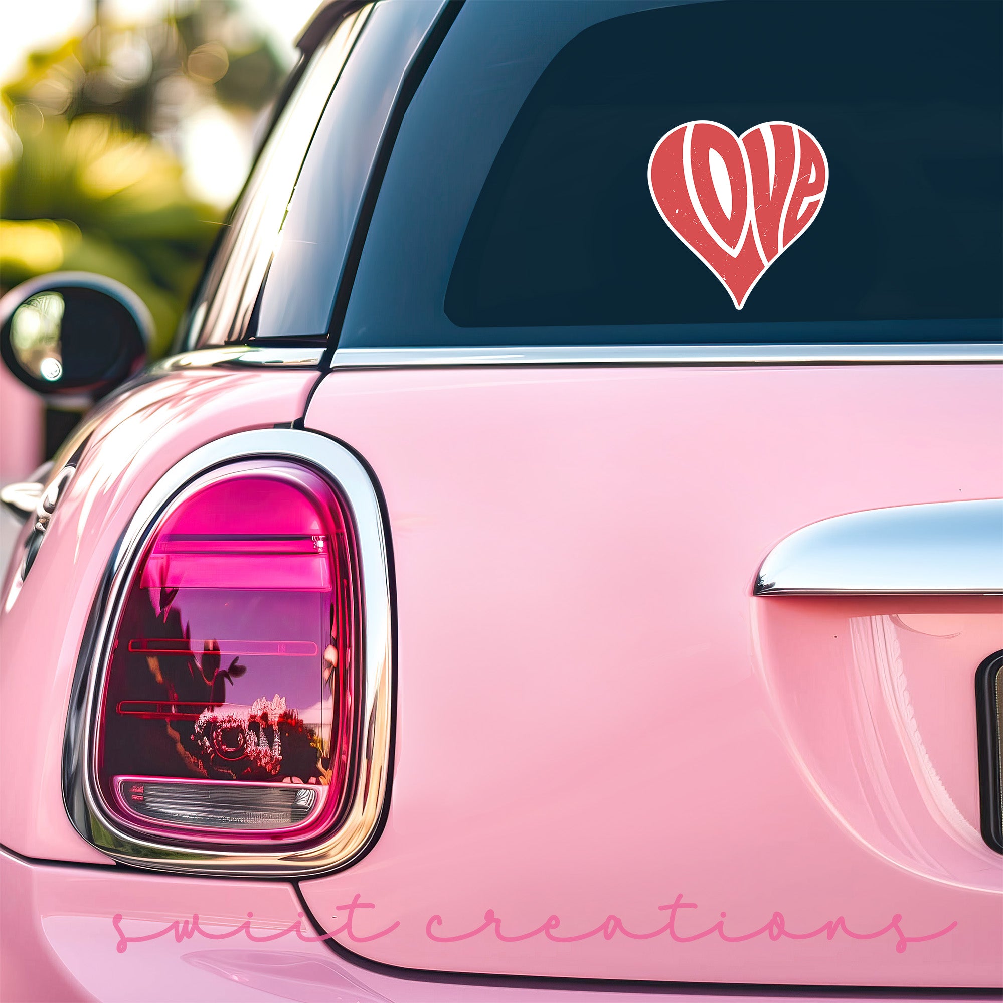 a pink car with a heart sticker on it