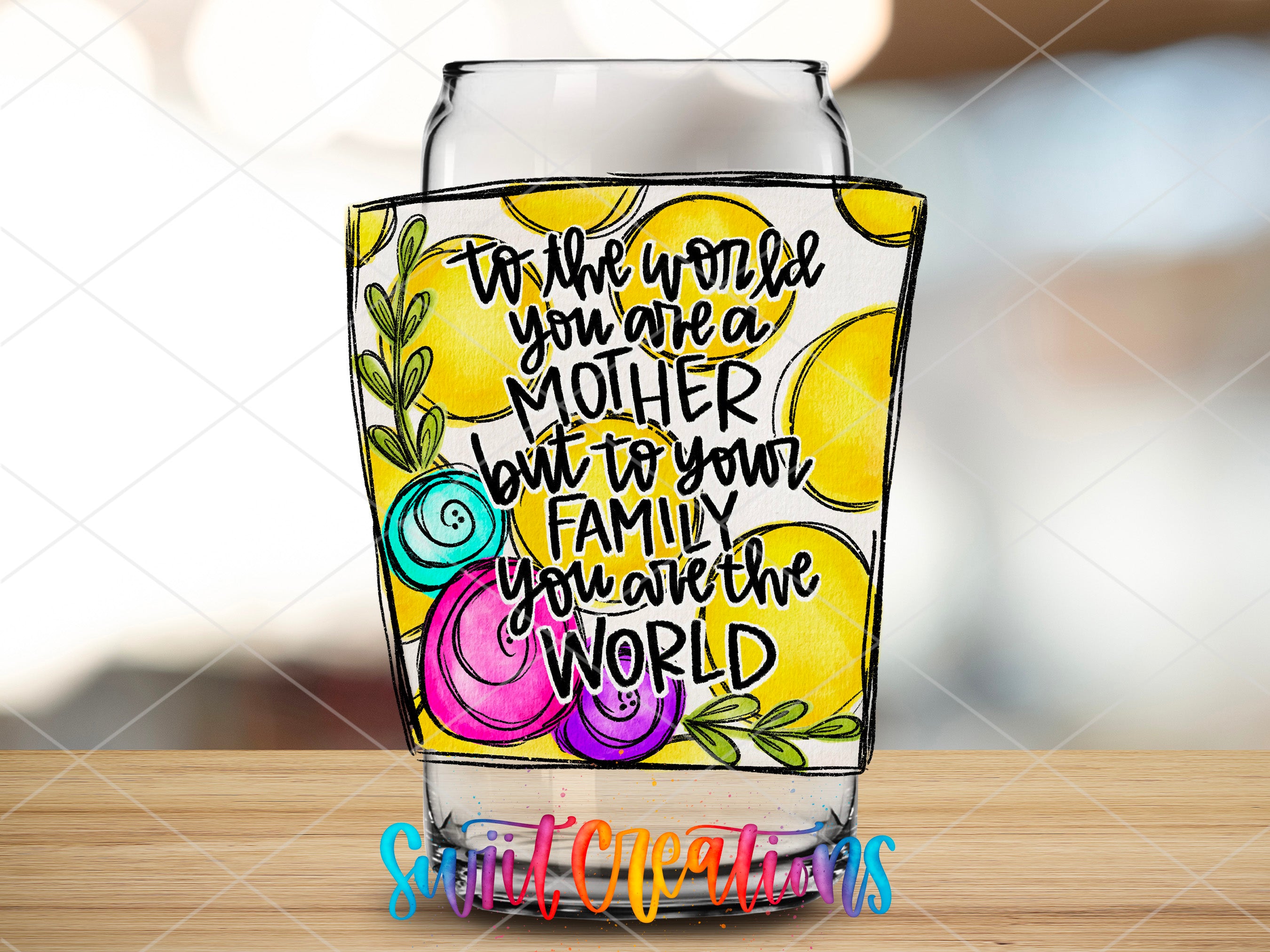 a glass with a quote on it sitting on a table