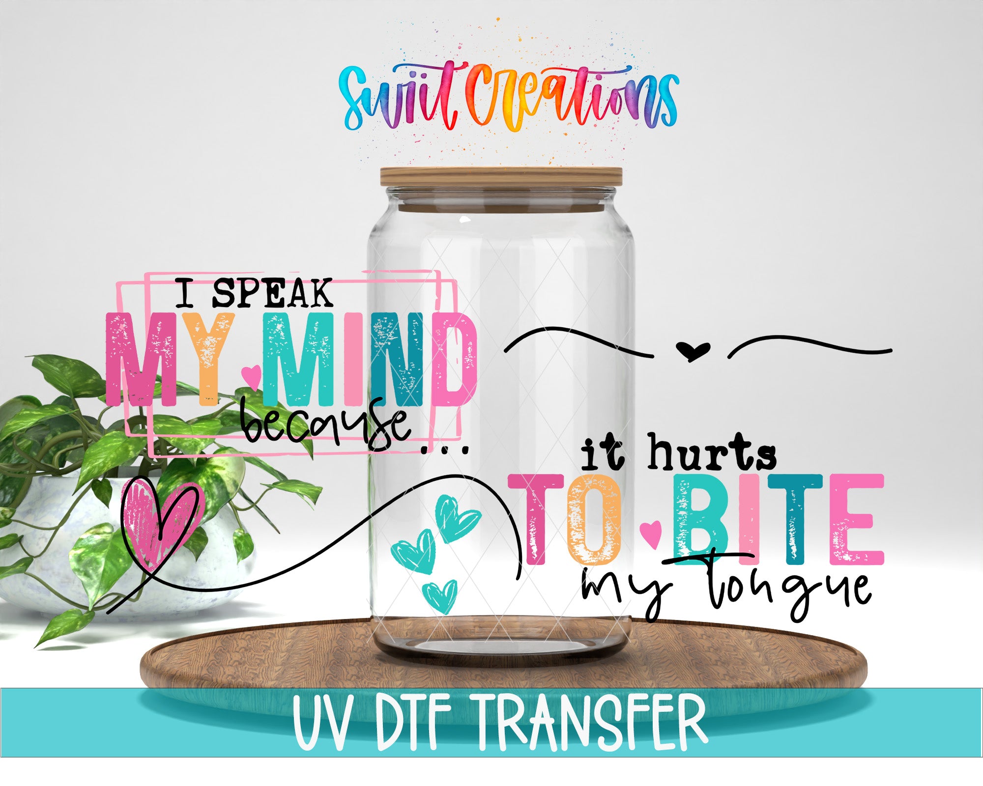 The image is a colorful and artistic representation of a glass jar with a wooden lid, accompanied by a plant and a wooden board. The text on the jar reads "I SPEAK MY MIND because... IT HURTS TO BITE my tongue" and "UV DFT TRANSFER".