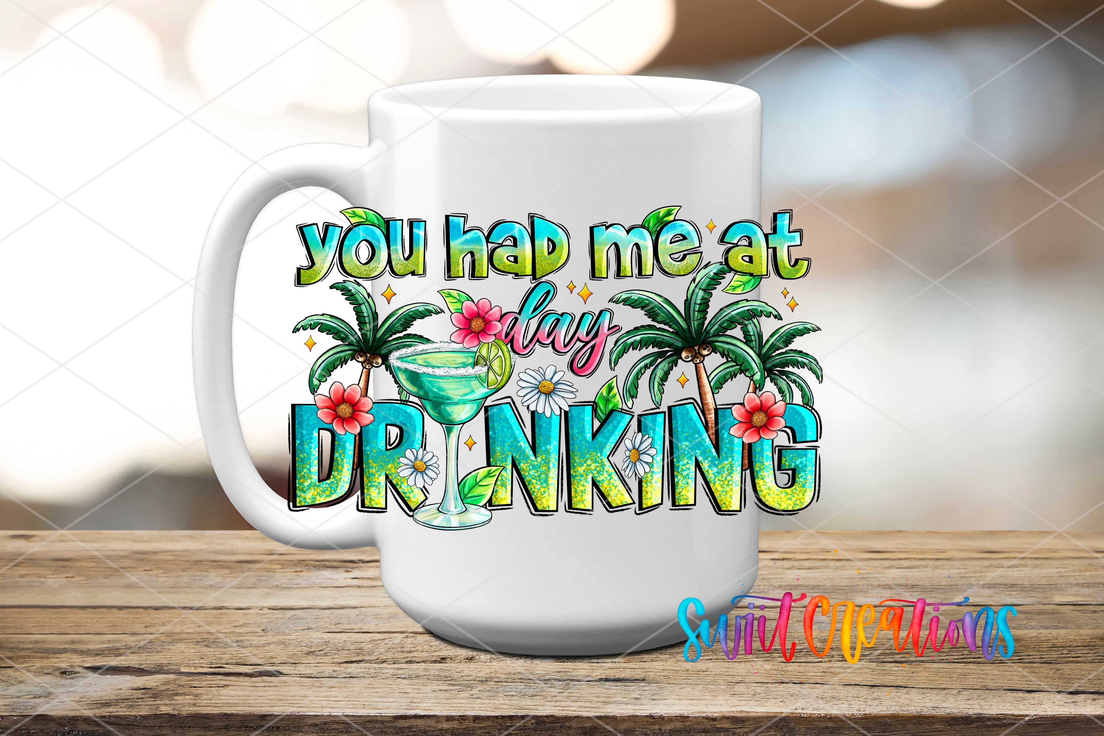 A white mug with a colorful graphic design featuring text and tropical elements, such as palm trees and flowers, on a wooden surface.