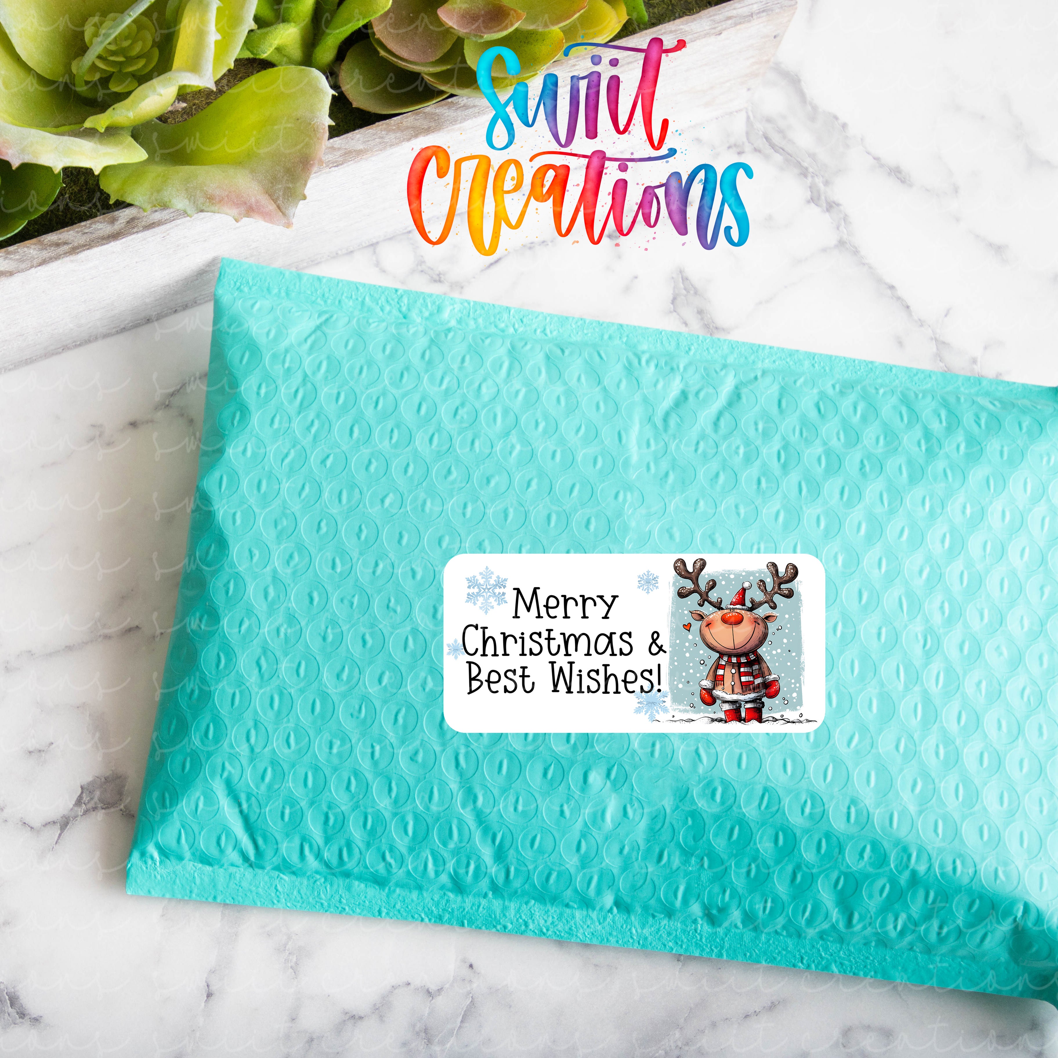 a blue envelope with a christmas sticker on it
