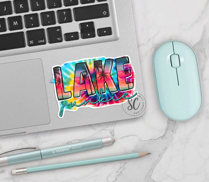 Lake Junkie vinyl sticker on a silver laptop next to a mint mouse and pens