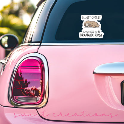 Dramatic Sloth sticker on the back window of a pink car
