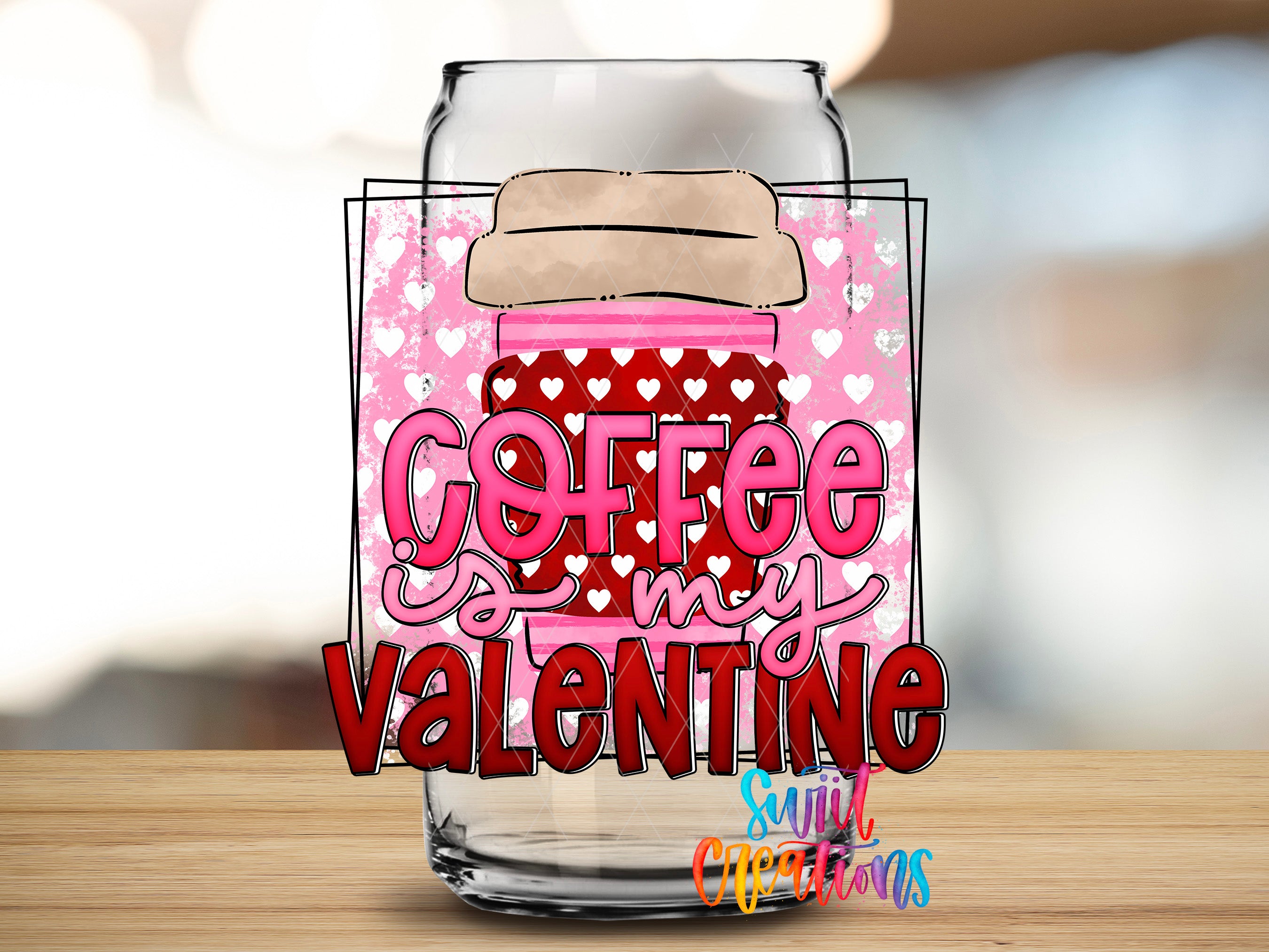 A glass jar with a heart-patterned lid and the text "Coffee my Valentine" printed on it, along with a blurred background.