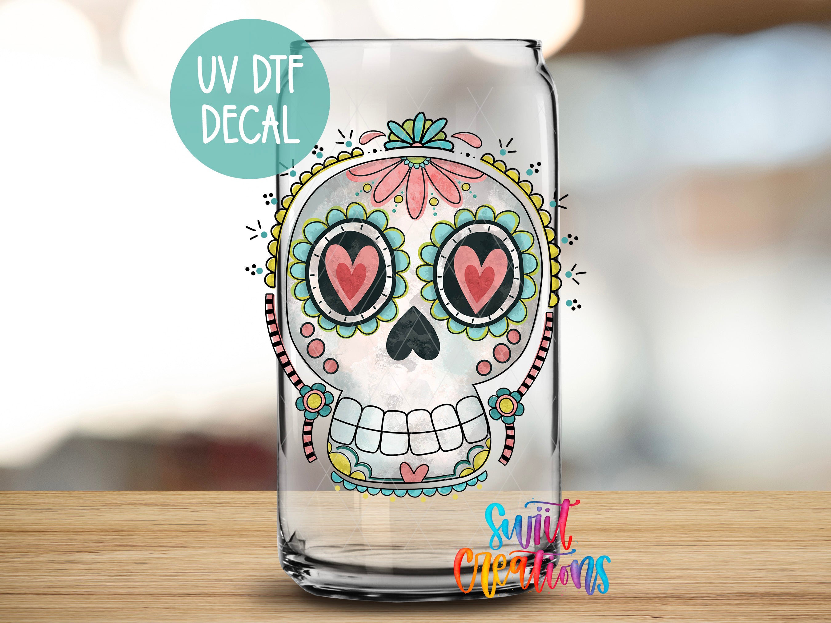 A glass jar with a colorful, decorative skull design on it, featuring a floral pattern and heart-shaped eyes.