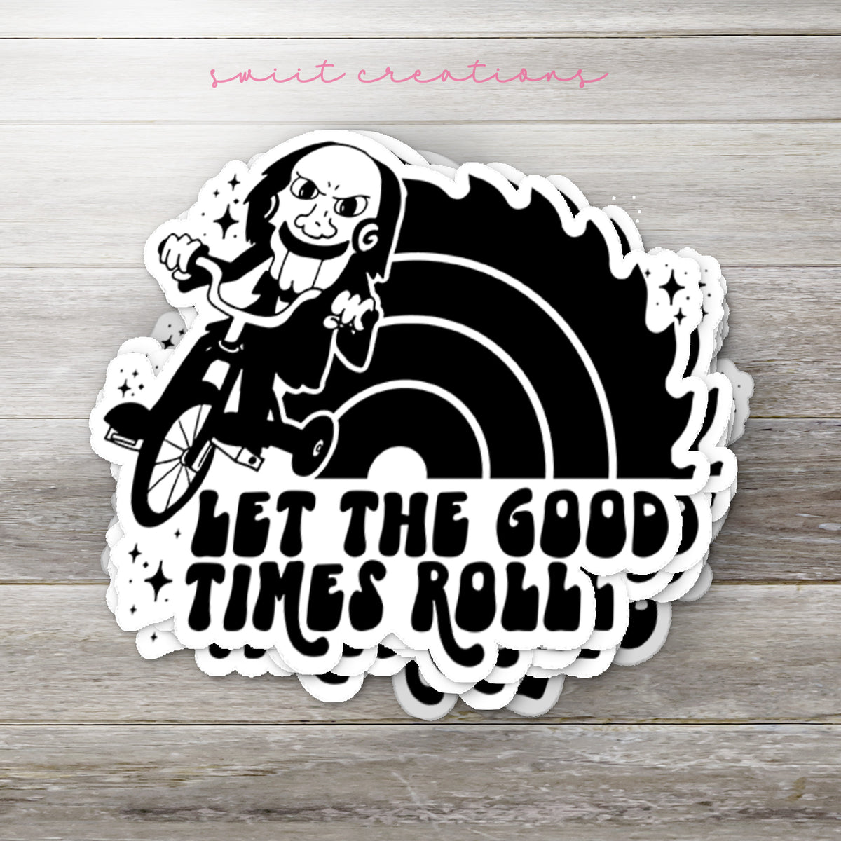 Stack of Let the Good Times Roll Horror glossy stickers on a gray wood table