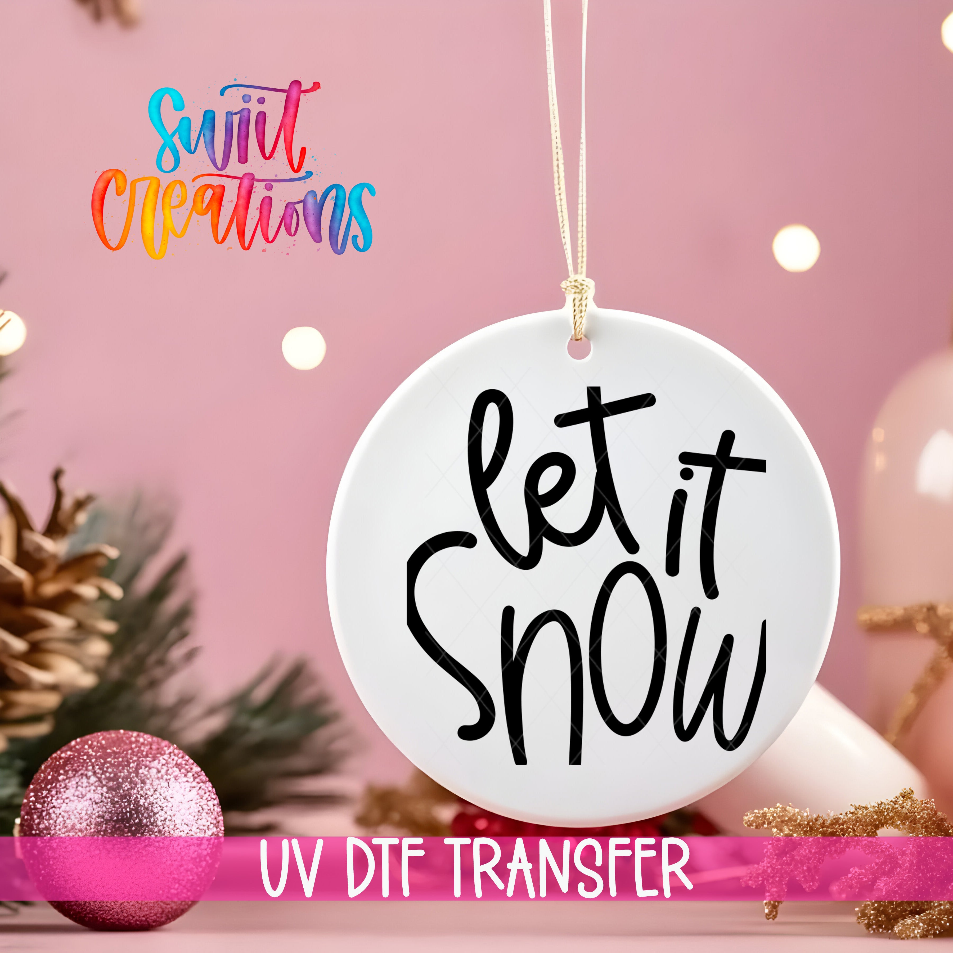 A white ornament with the text "let it snow" is hanging on a string against a pink background, with Christmas decorations and a pink glitter ornament visible in the background.