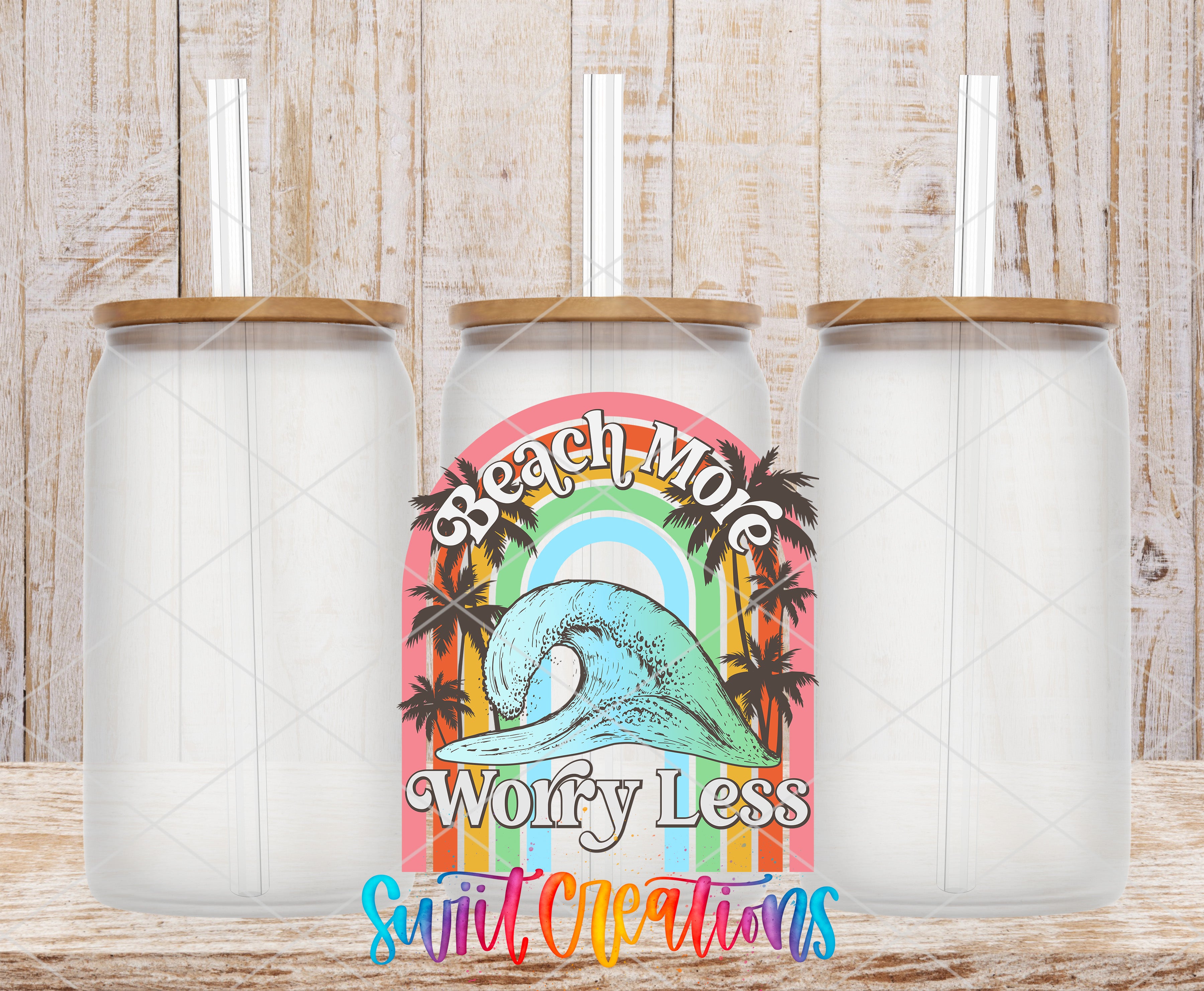 three glass jars with straws, each with a different design and color. The central jar has a colorful graphic and text that reads "Beach More Worry Less Surfless Creations".