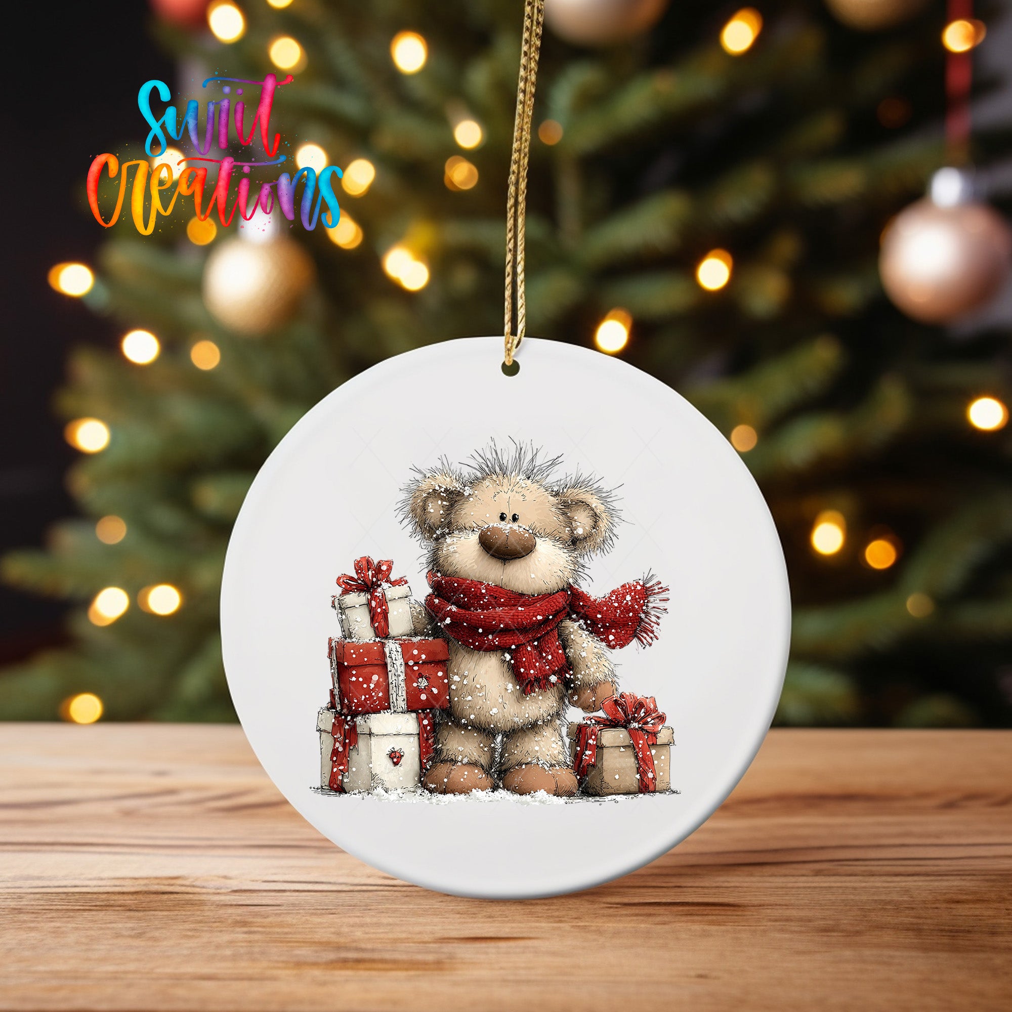A white ceramic ornament featuring a teddy bear wearing a red scarf and holding presents, with a Christmas tree in the background.