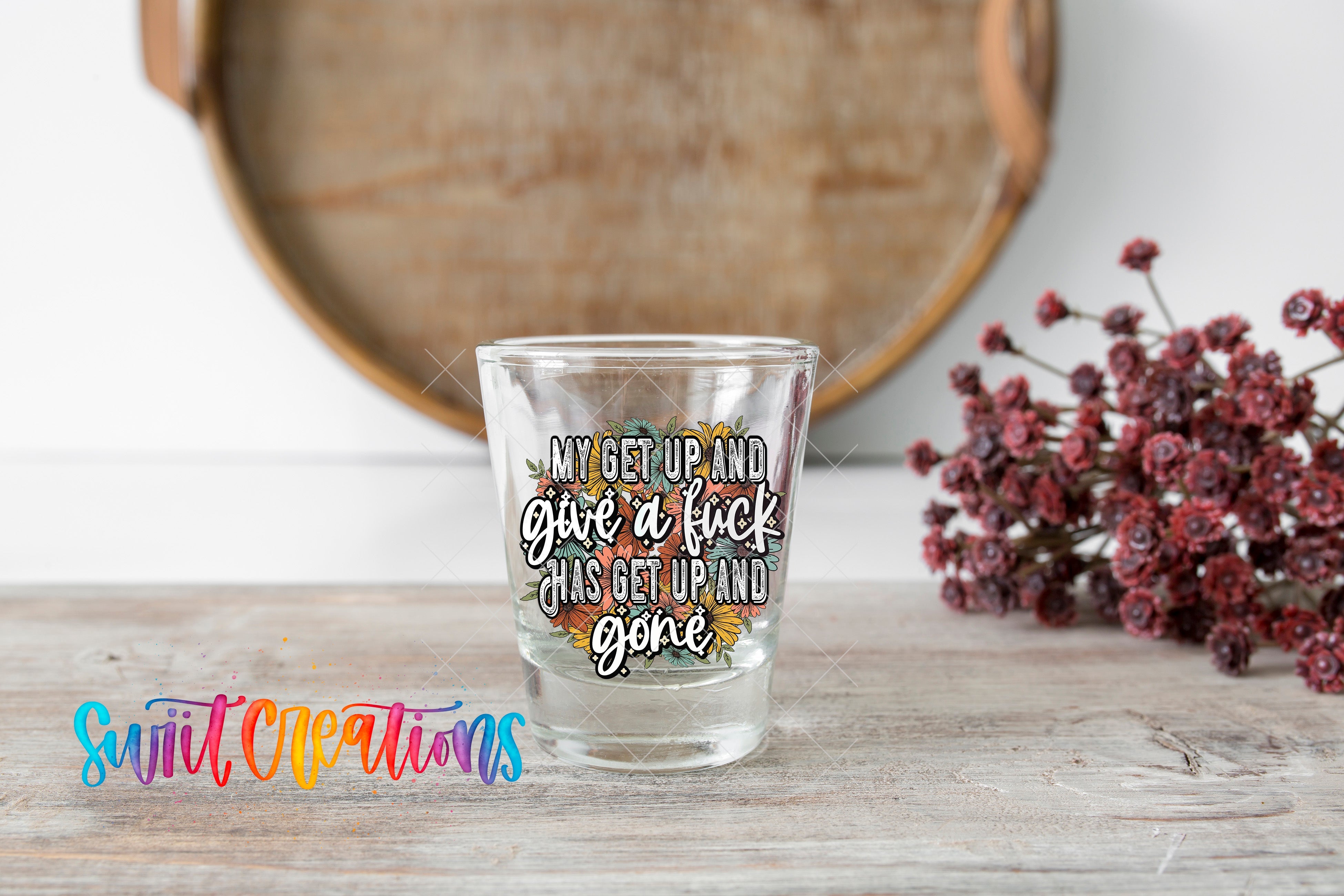 a shot glass sitting on top of a wooden table