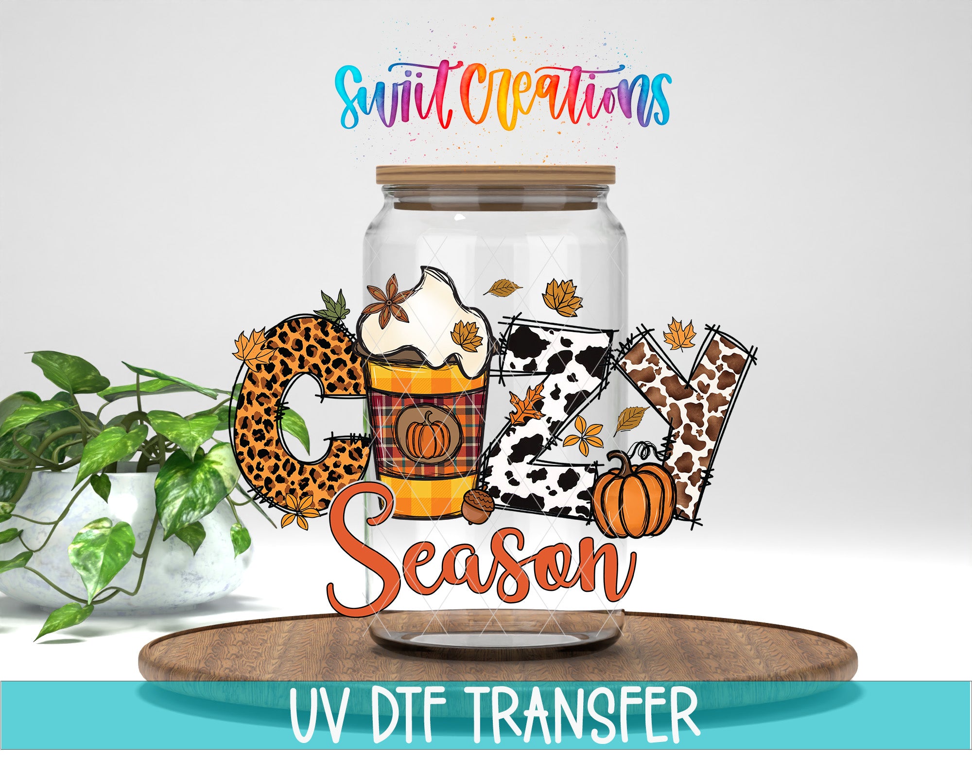 A glass jar with a lid, decorated with autumn-themed elements such as leaves, pumpkins, and a coffee cup, along with the text "Cuddle Season" and "Swift Creations".
