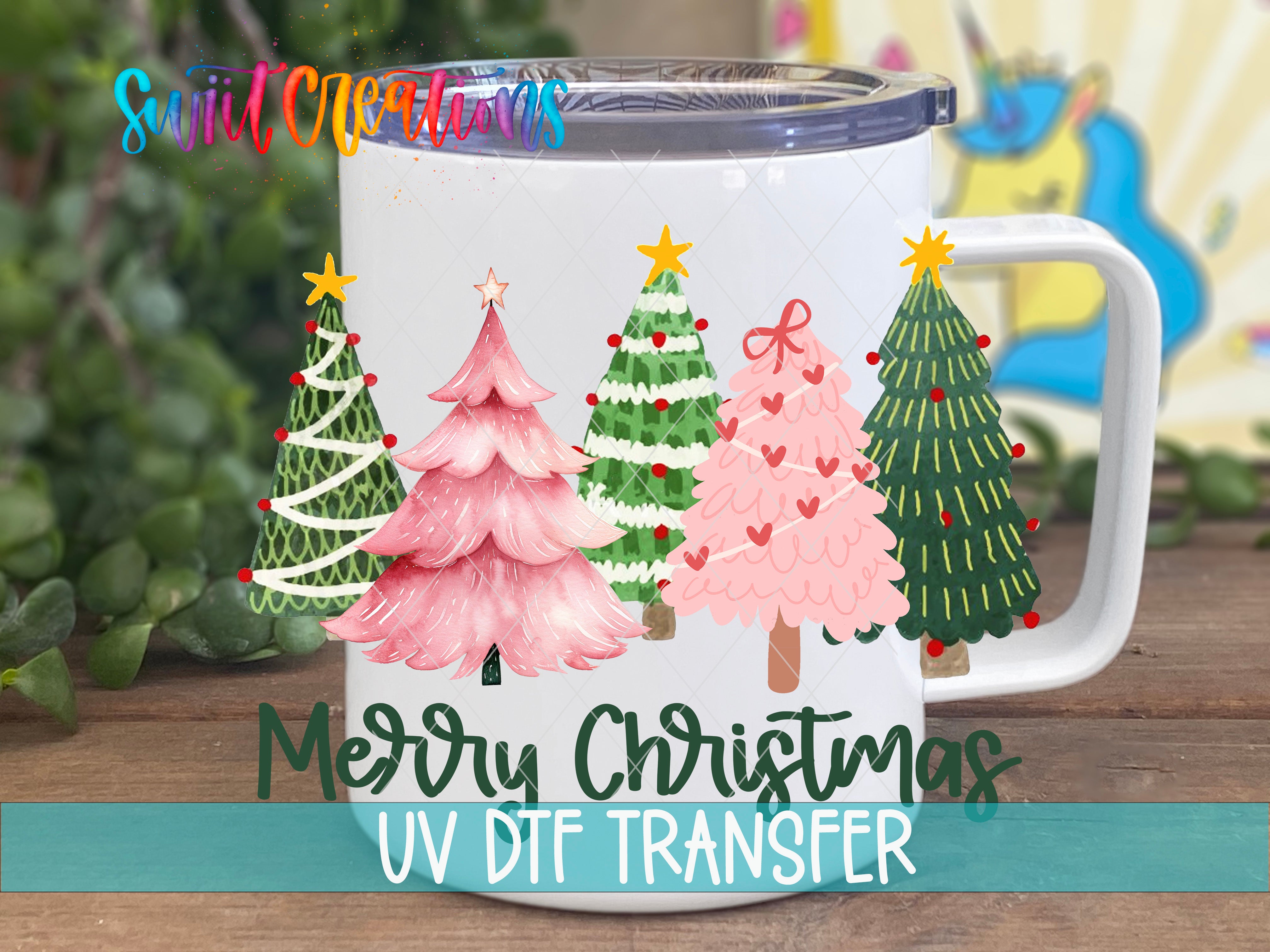 A white mug with a Christmas tree design printed on it, placed on a wooden surface.