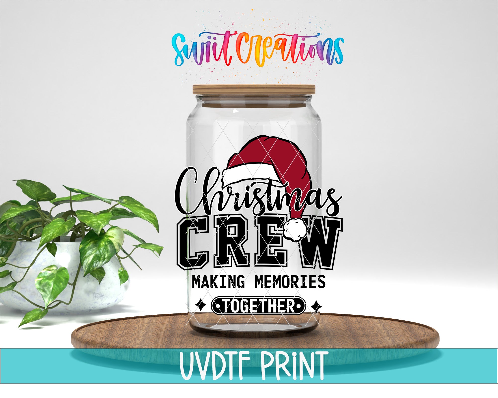 A glass jar with a Christmas-themed design, including a Santa hat and the text "Christmas Crew Making memories together". The jar is placed on a wooden tray, and there is a potted plant in the background.