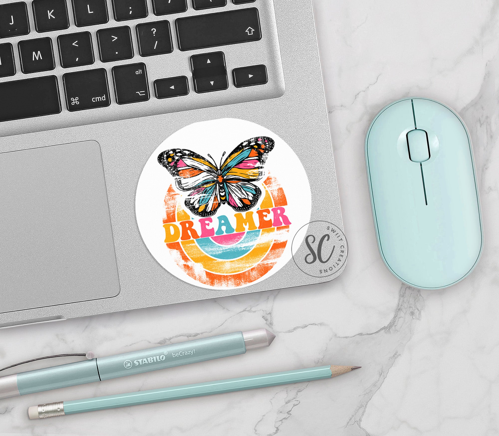 a laptop with a sticker of a butterfly on it