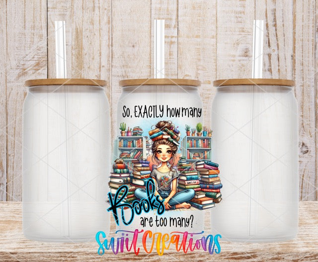 two white coffee mugs with a girl sitting on a stack of books