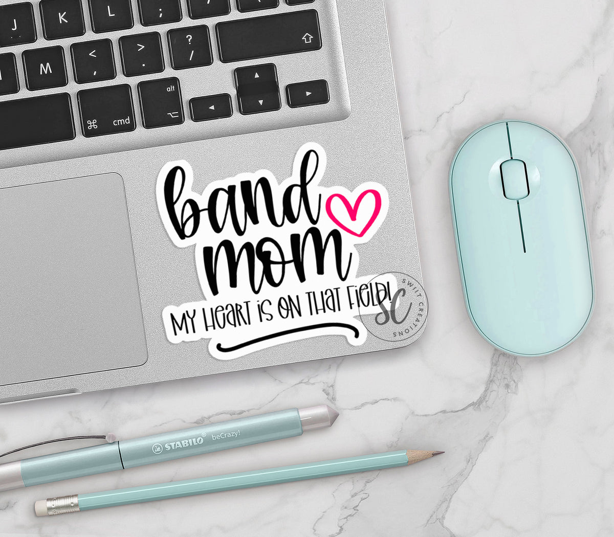 a laptop with a sticker that says band mom on it