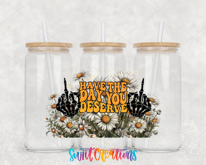 Have the Day You Deserve skeleton hands and daisies UV DTF wrap on three glass cans