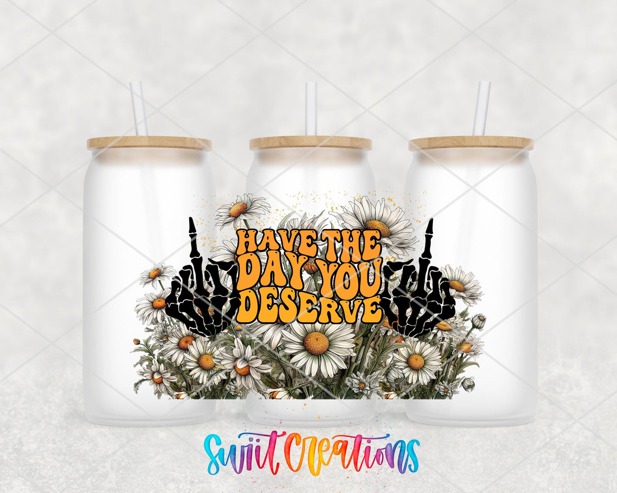 Have the Day You Deserve skeleton hands and daisies UV DTF wrap on three frosted glass cans