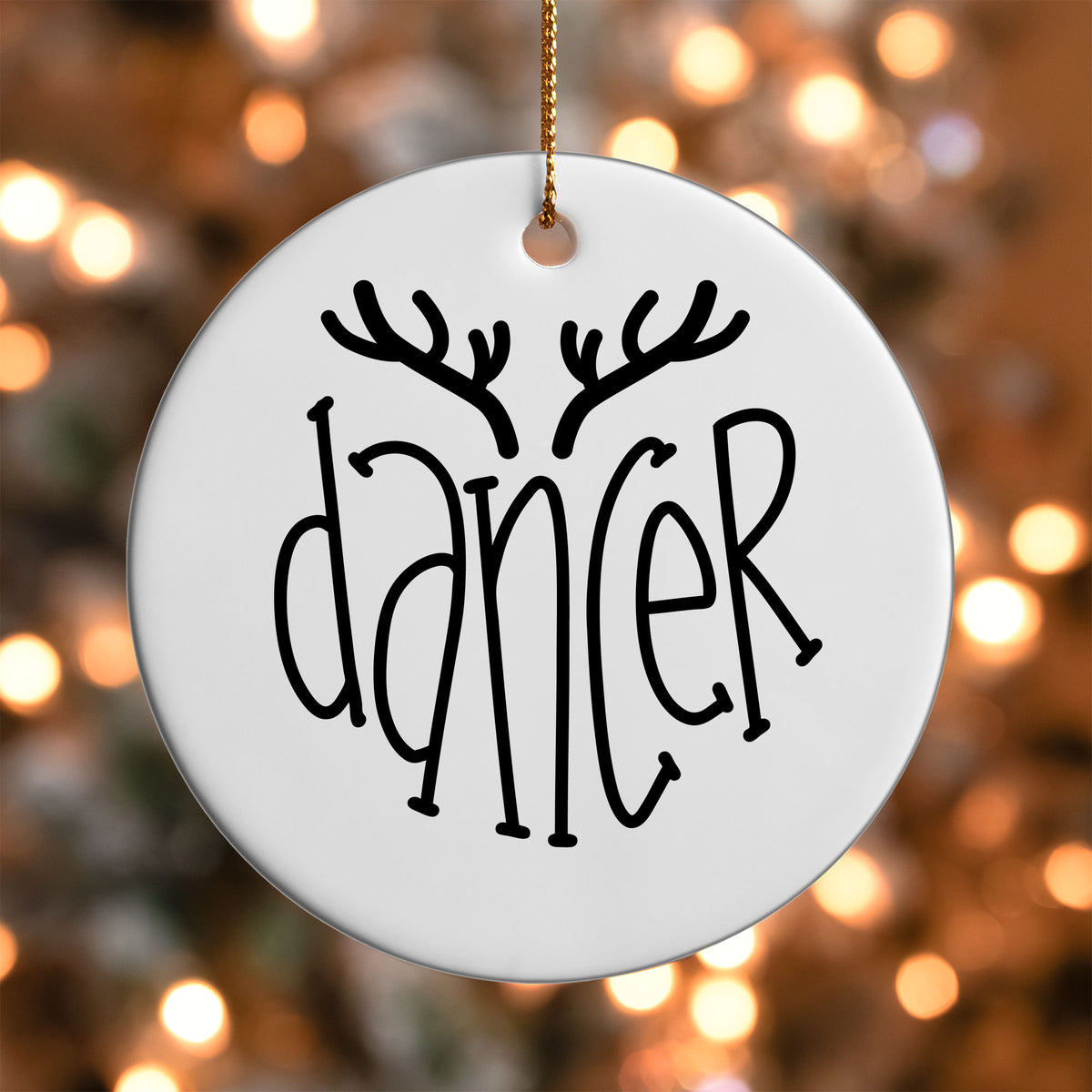 Dancer Reindeer Name ornament UV DTF transfer on a round white ornament with a bokeh light background