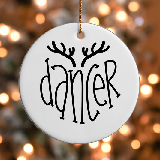 Dancer Reindeer Name ornament UV DTF transfer on a round white ornament with a bokeh light background
