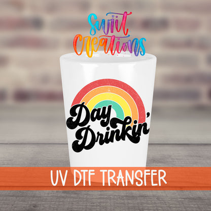 Day Drinkin' UV DTF transfer on a white shot glass in front of a brick wall