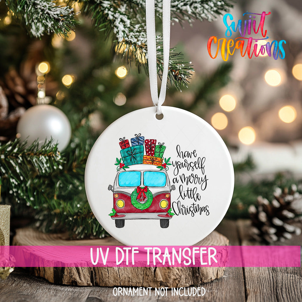 A white ceramic ornament with a red and white van design, surrounded by Christmas decorations and lights.