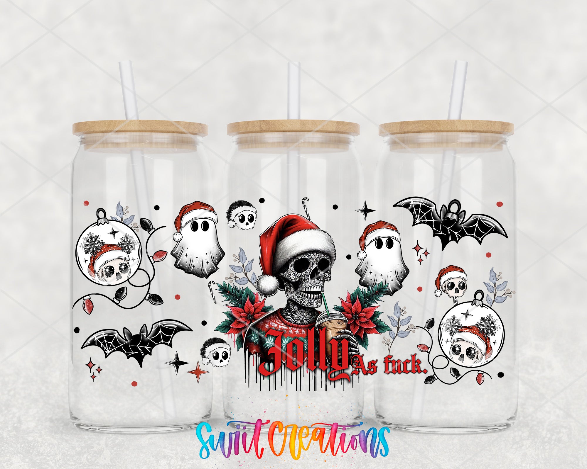 a set of three christmas themed tumblers with skulls and bats on them